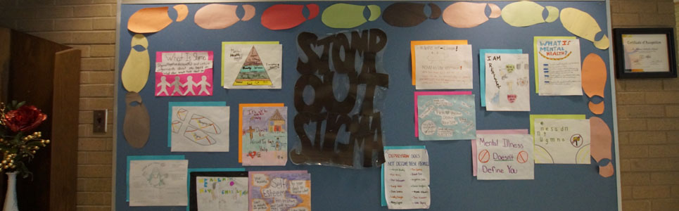 Mental Health bulletin board with the saying, "Stomp Out Stigma".